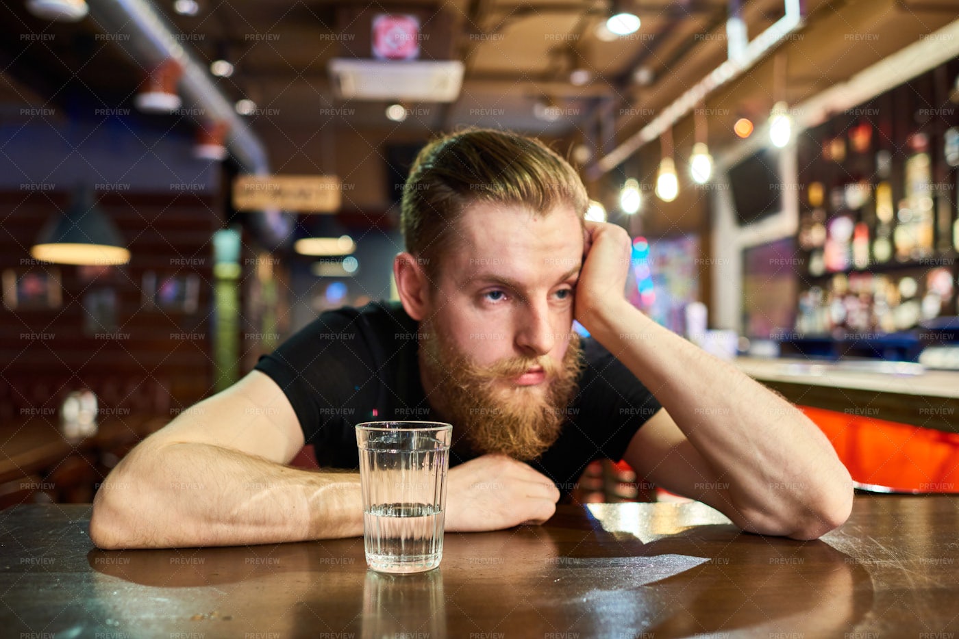 Sad Bearded Man Getting Drunk In...: Stock Photos