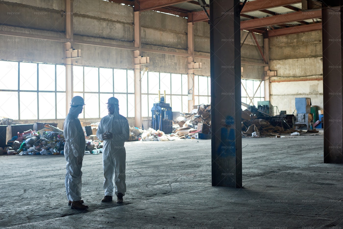 Workers In Empty Waste Processing...: Stock Photos