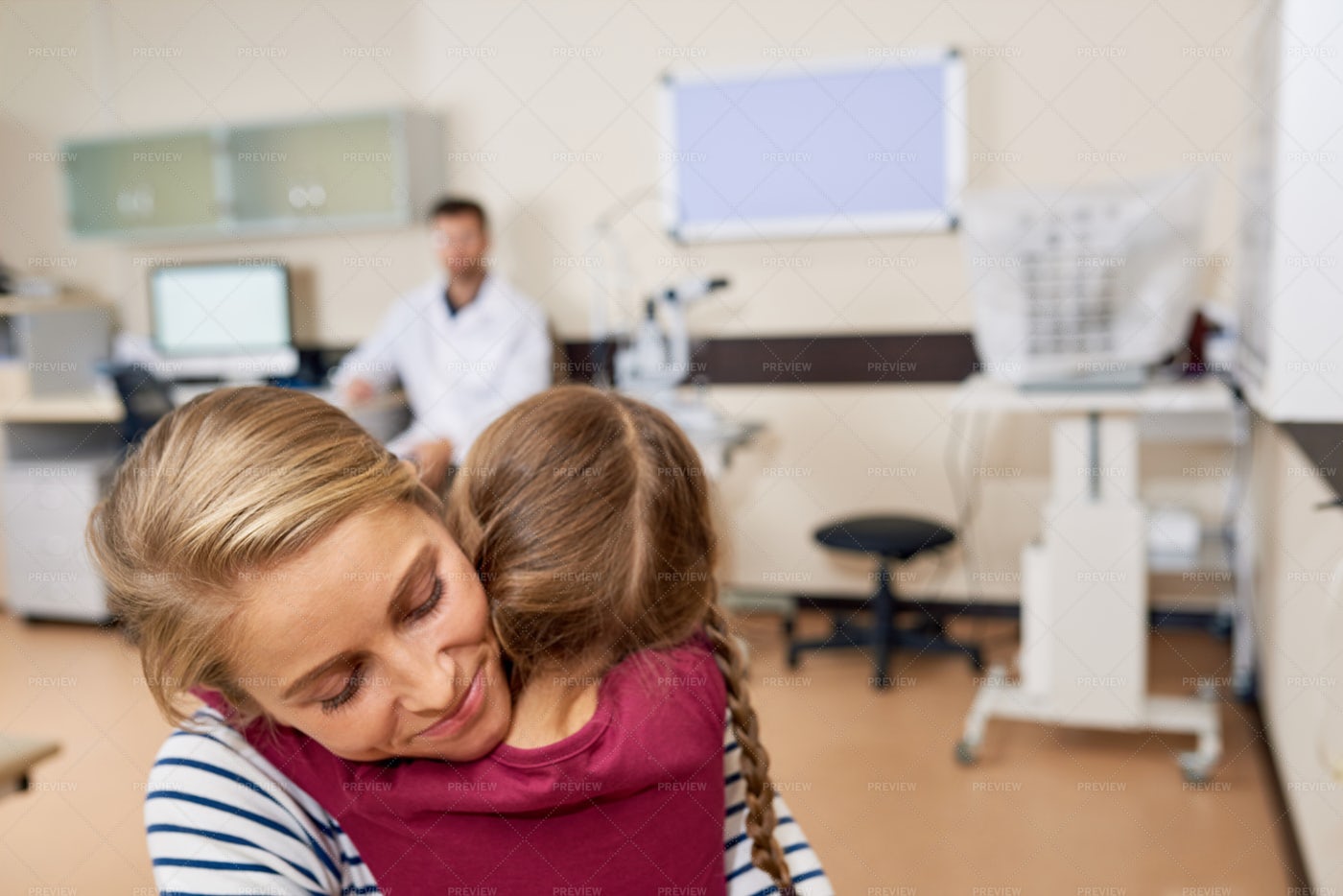 Little Girl Hugging Mom In Doctors...: Stock Photos