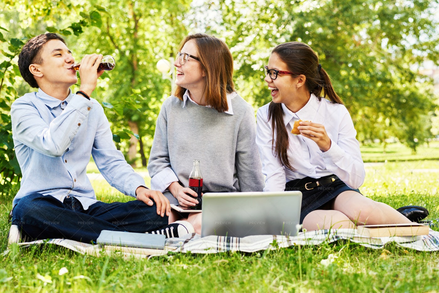 Teenage Kids Relaxing On Green Lawn: Stock Photos