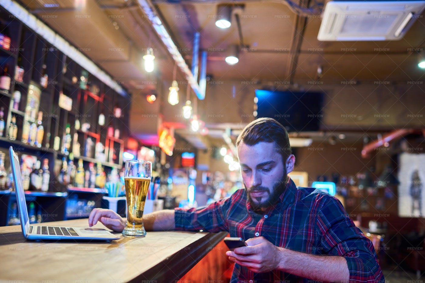 Man Using Smartphone In Pub: Stock Photos