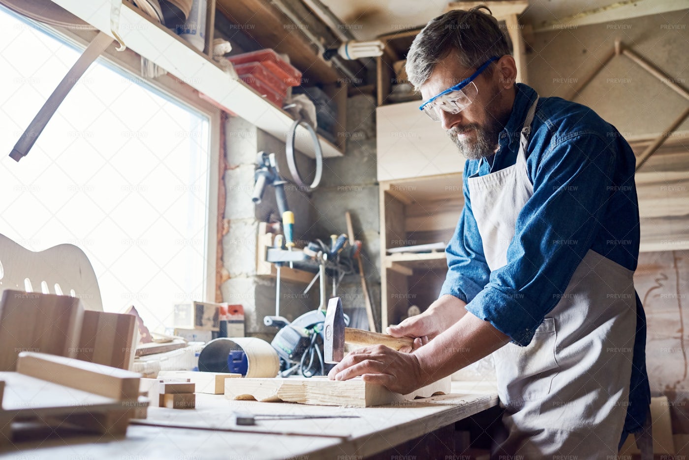 Hammering Nails Into Board: Stock Photos