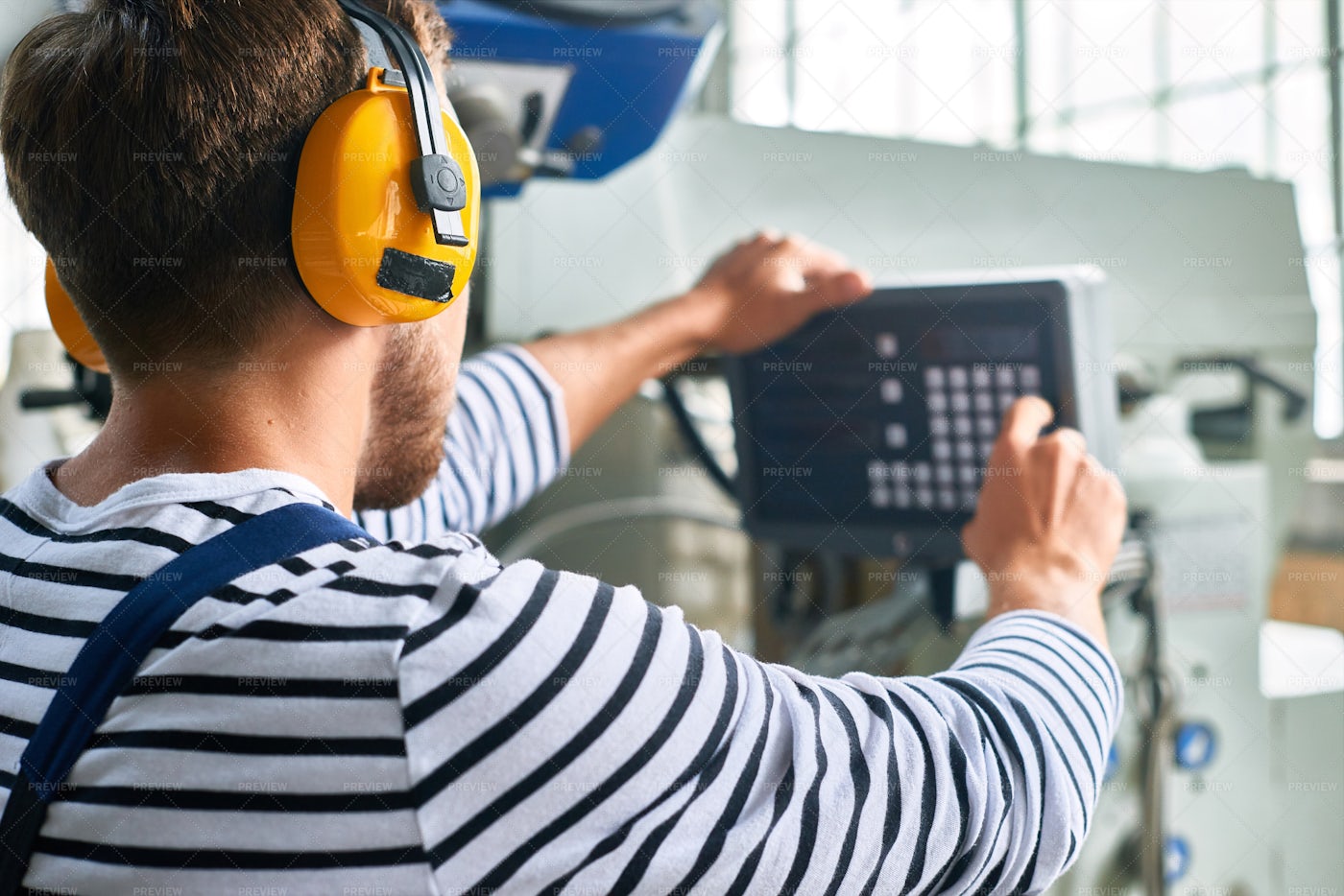 Operator Setting Up Machine Units...: Stock Photos