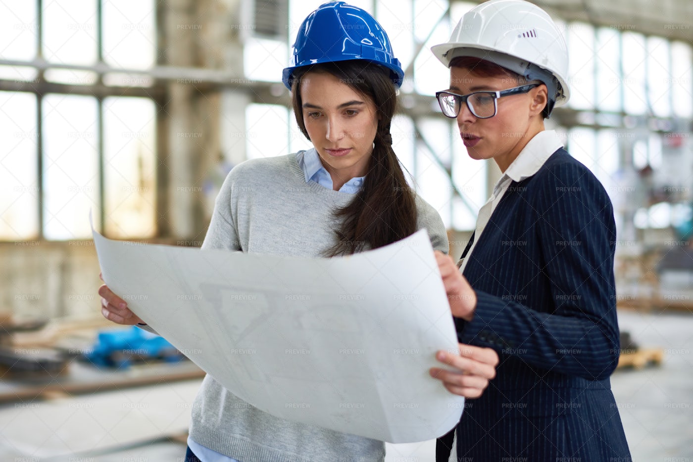 Female Architect Explaining...: Stock Photos
