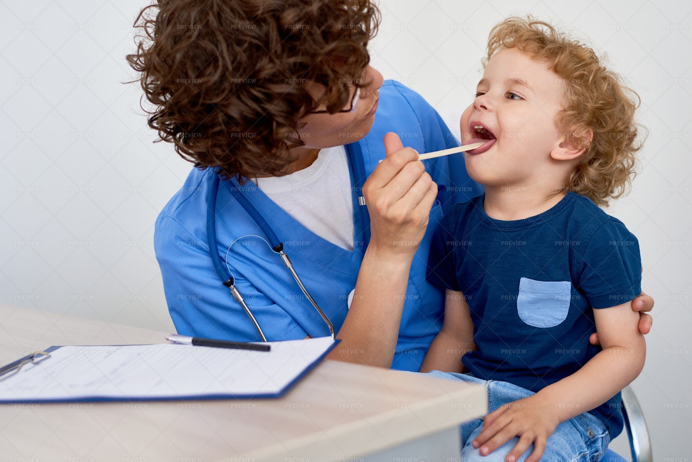 Nurse Examining Little Boy: Stock Photos