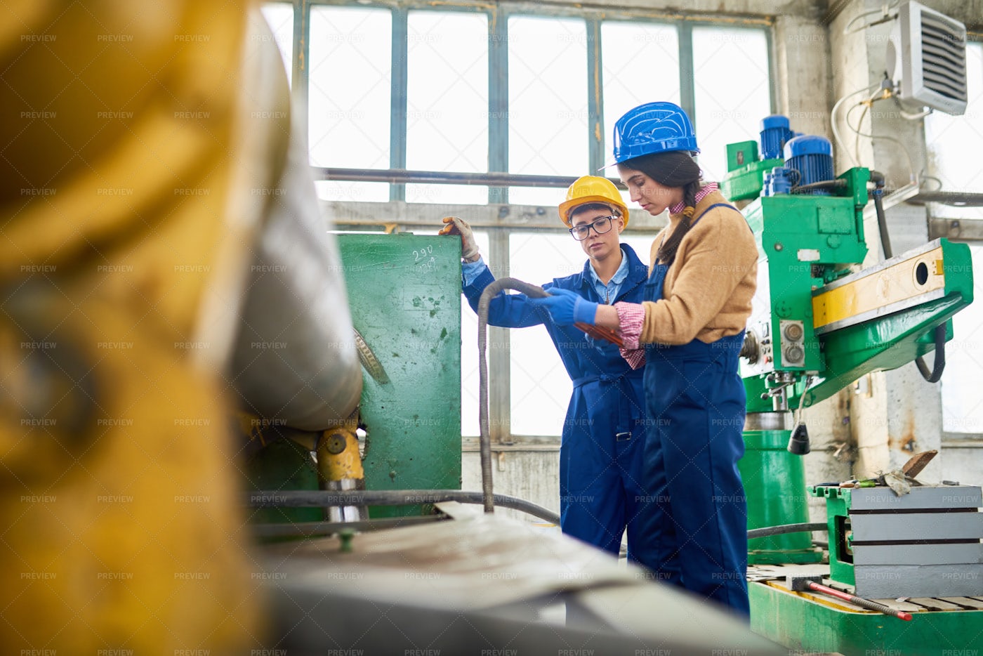 Modern Women Working On Machine: Stock Photos