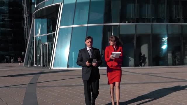 Businesswoman And Businessman Walking: Stock Video