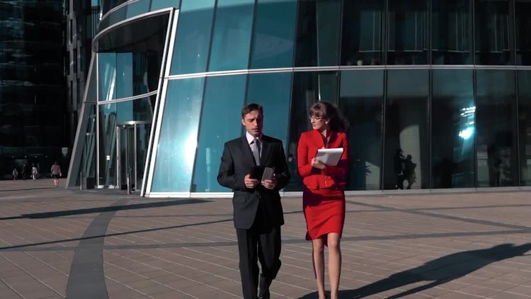 Businesswoman And Businessman Walking: Stock Video