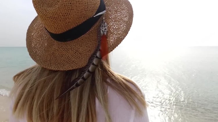 Woman Walking Down A Beach: Stock Video