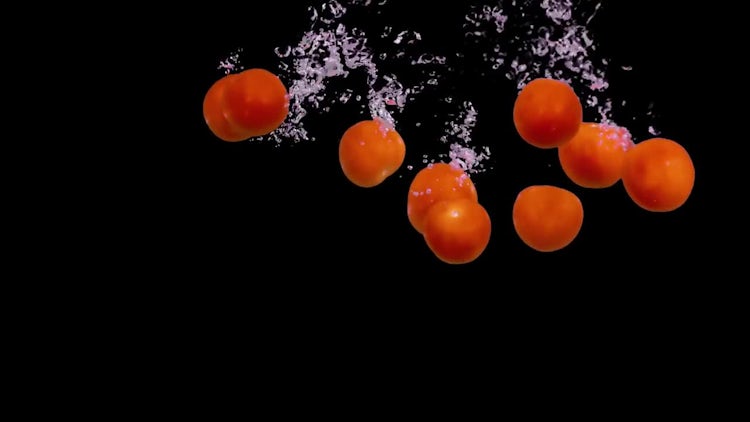 Tomatoes Dropped In Water: Stock Video