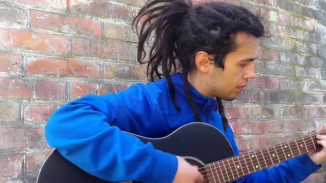 Young Man With Dreadlocks Playing Guitar: Stock Video