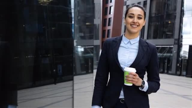 Smiling Businesswoman Holding a Coffee: Stock Video