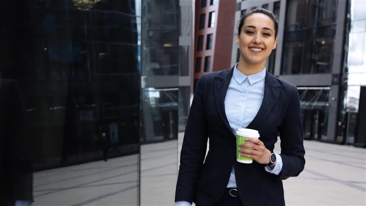 Smiling Businesswoman Holding a Coffee: Stock Video
