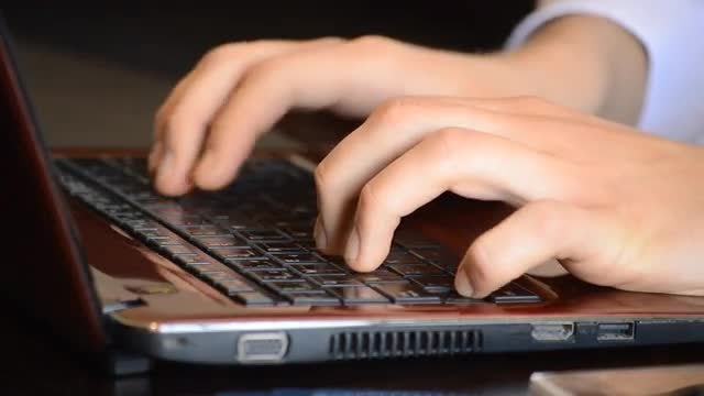 Typing On A Red Laptop: Stock Video