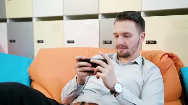 Excitedly Playing On Smartphone: Stock Video