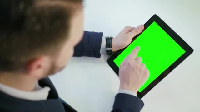 Man Using A Tablet With A Green Screen: Stock Video