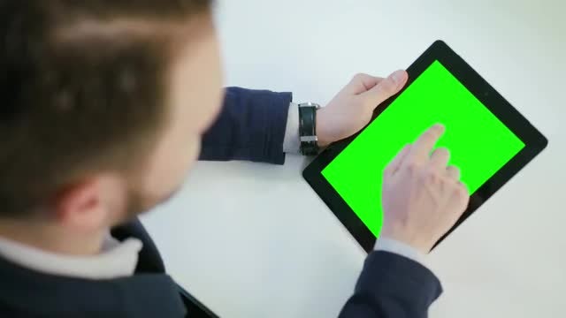 Man Using A Tablet With A Green Screen: Stock Video