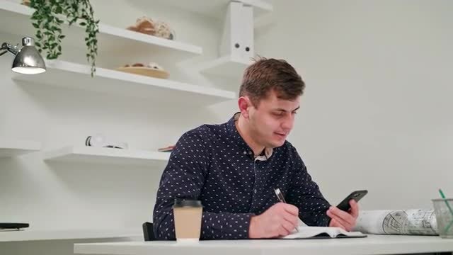 Young Man Taking Notes: Stock Video