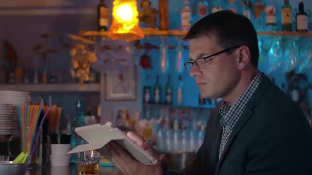 Man Working On IPad At A Bar: Stock Video