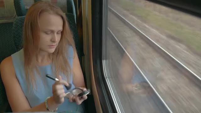 Woman Applying Makeup On Train: Stock Video