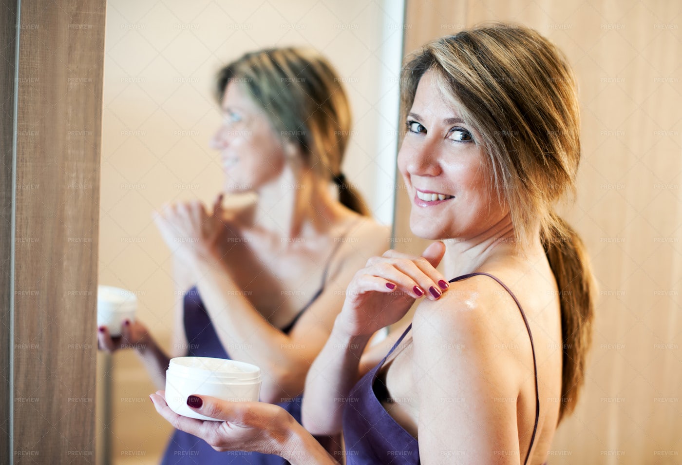 Woman Applying Cream: Stock Photos