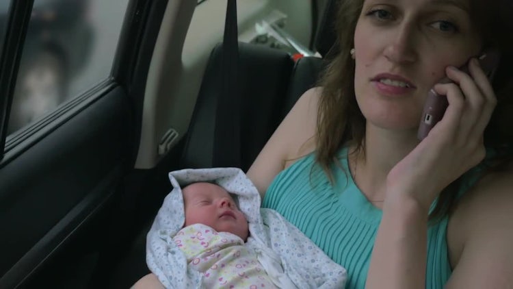 Young Mother Talking On Phone: Stock Video