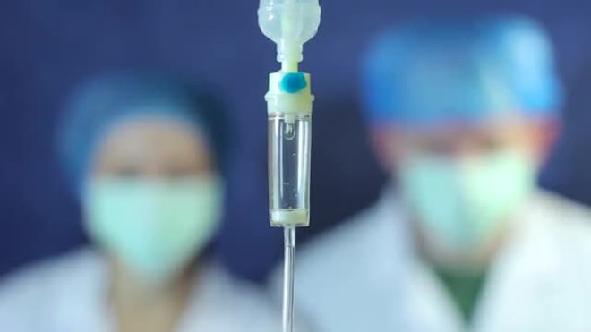 Intravenous Drip With Doctors Behind - Stock Video | Motion Array