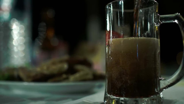 Pouring Dark Beer Into Mug: Stock Video