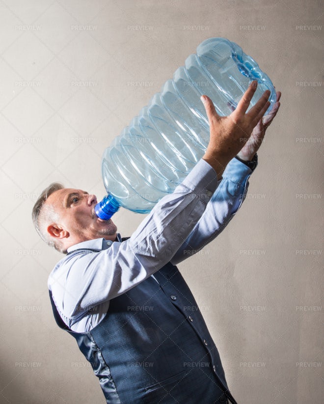 Drinking From A Giant Water Bottle - Stock Photos