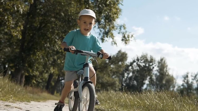Little Boy Enjoys Bike Ride: Stock Video