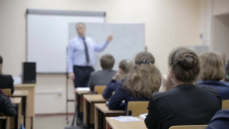 Teacher Teaching Students In Class: Stock Video