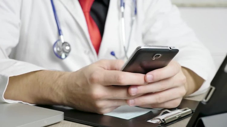 Doctor Using Smartphone In Office: Stock Video