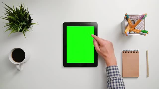 Man Scrolling On Green Tablet: Stock Video