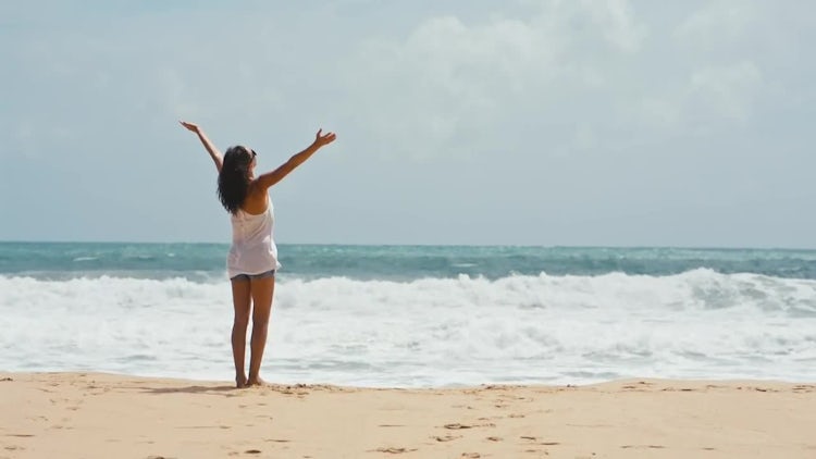 Woman lifts hands up on the sea background: Stock Video