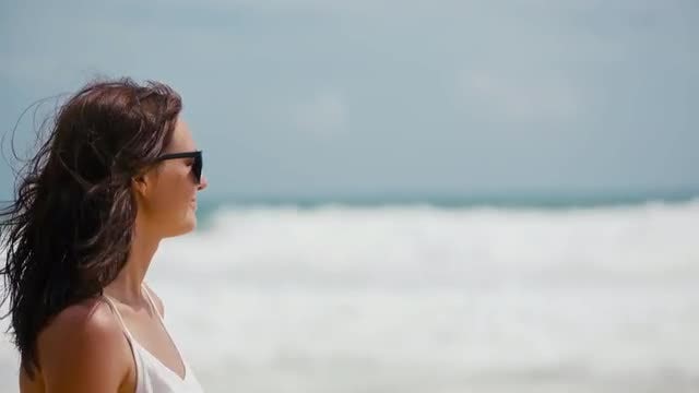 Woman Standing On The Beach: Stock Video