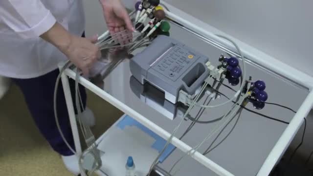 Cardiologist Handling An ECG Machine: Stock Video