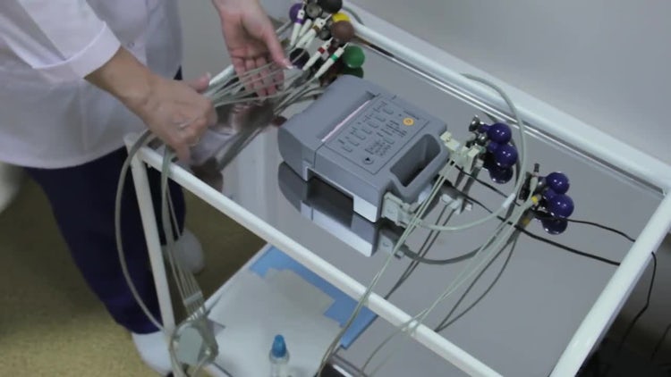 Cardiologist Handling An ECG Machine: Stock Video