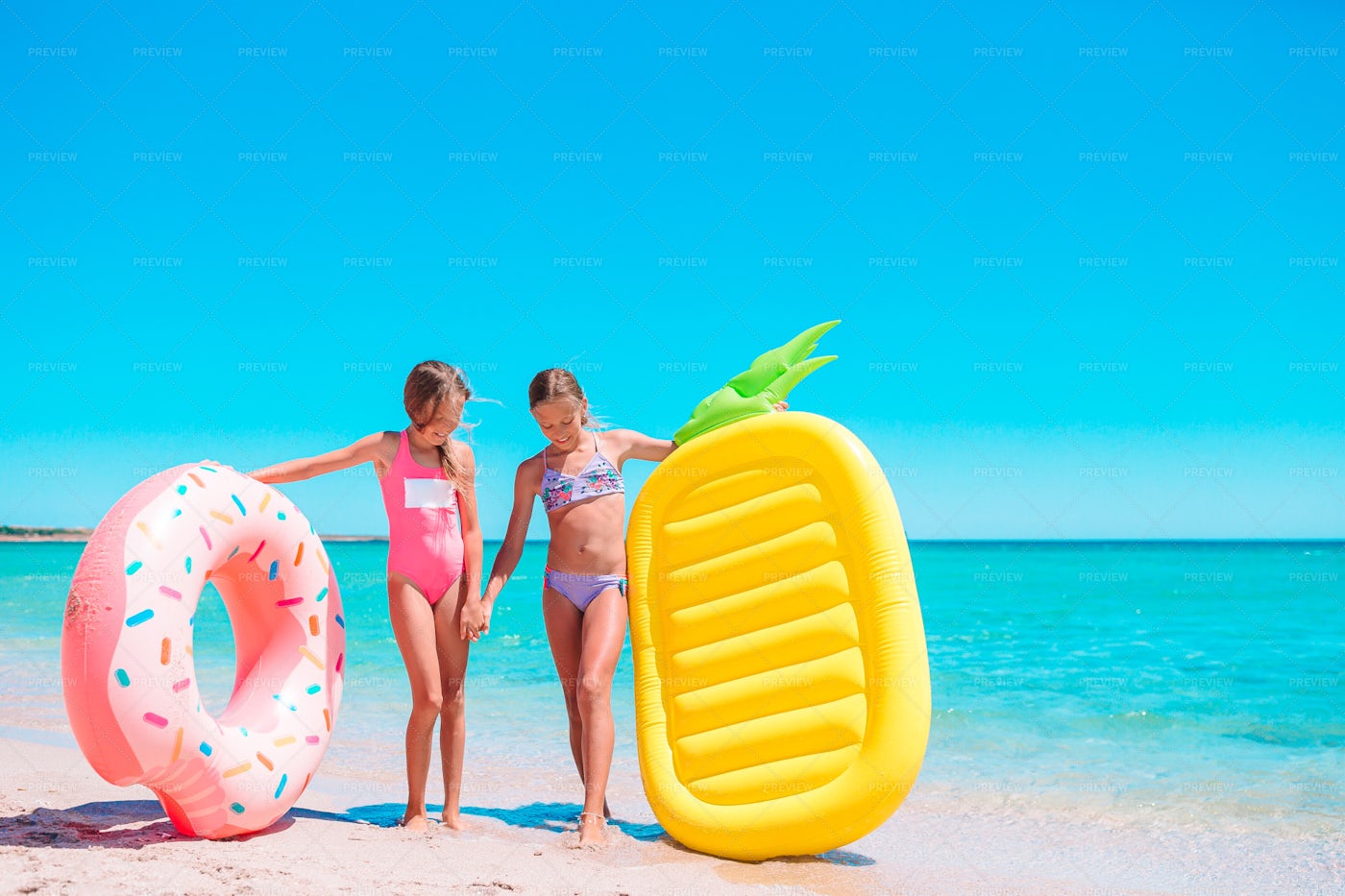 Girls With Their Inflatables: Stock Photos