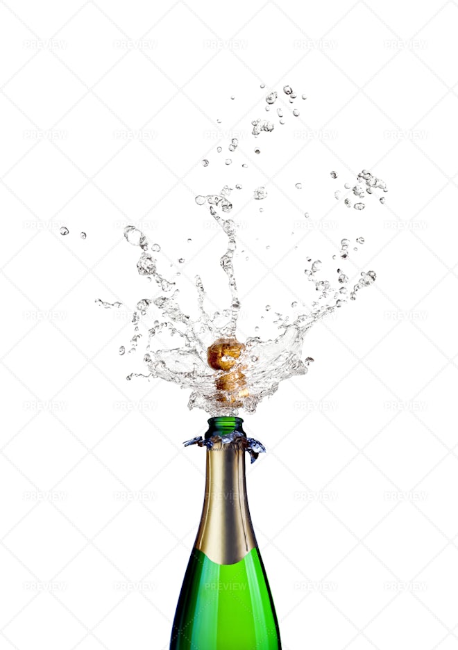 Champagne bottle popping on a white background