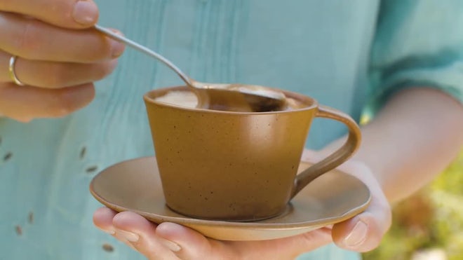 Stir the hot coffee in a cup with a spoo, Stock Video