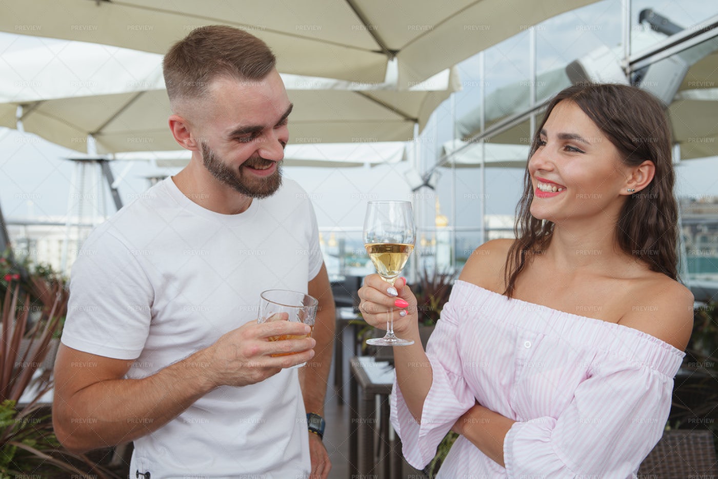 Couple Drinking Wine On A Rooftop: Stock Photos