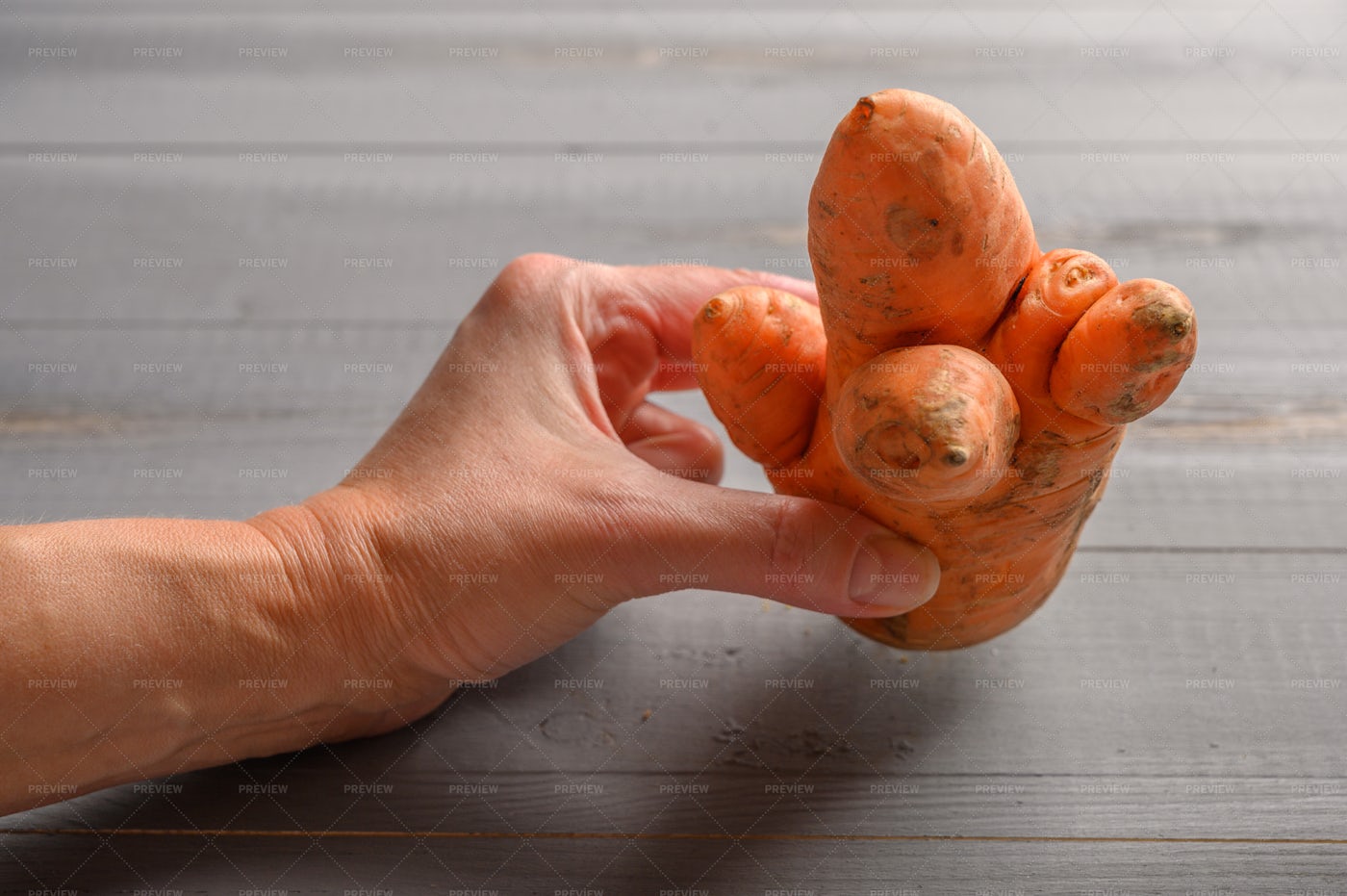 Holding An Ugly Carrot: Stock Photos