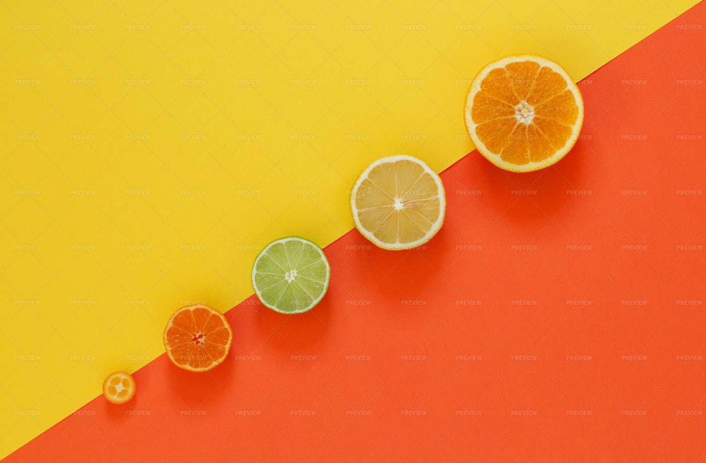 Citrus Fruits On Red And Yellow: Stock Photos