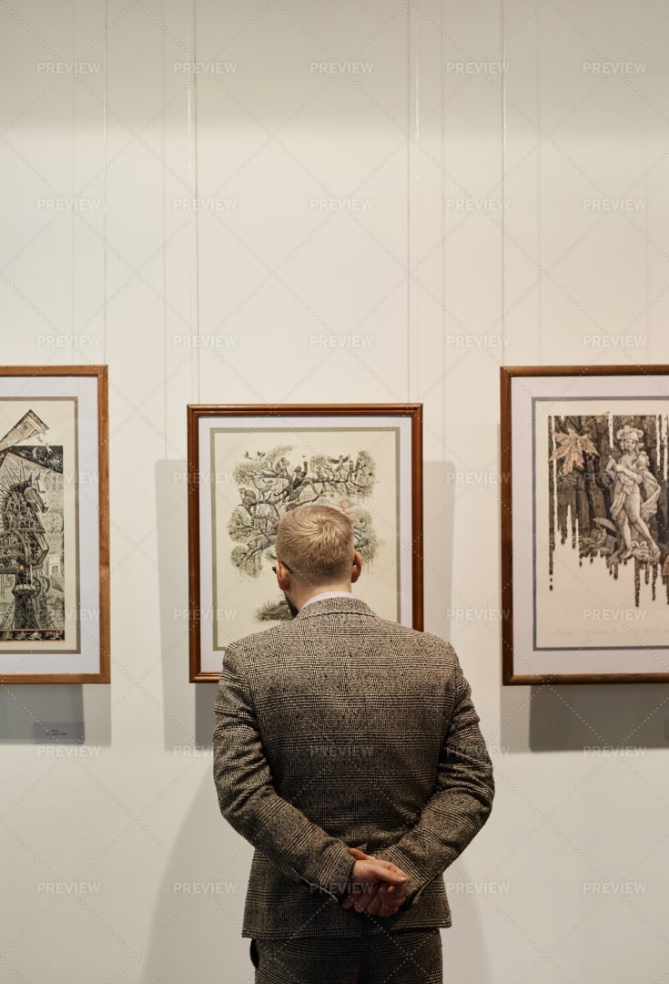 Man Looking At Paintings: Stock Photos