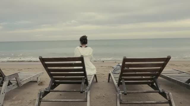 Woman Sitting On Beach Lounger: Stock Video