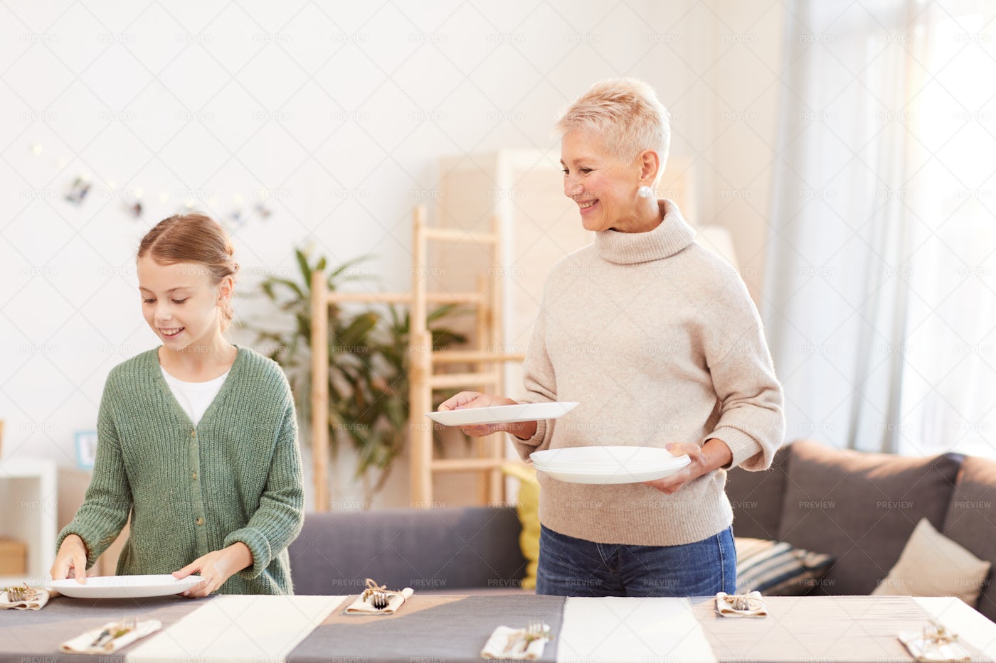 Mother And Daughter Prepre The Table: Stock Photos