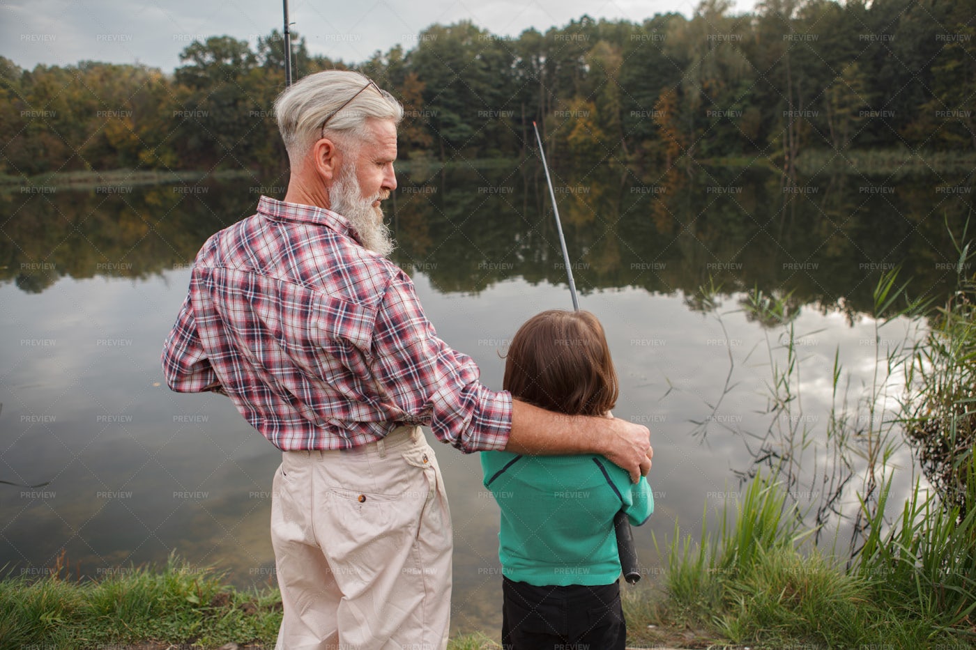 Grandpa Hugging Grandson While Fishing Stock Photos