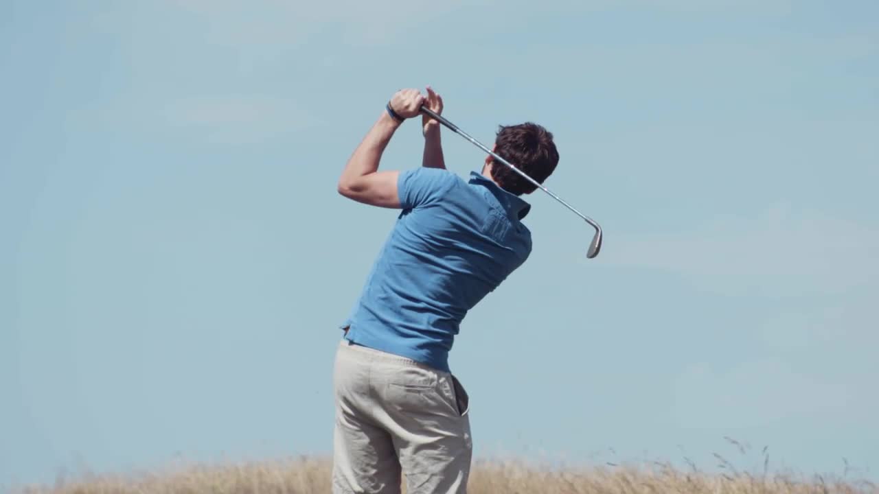 Man Swinging A Golf Club - Stock Video | Motion Array