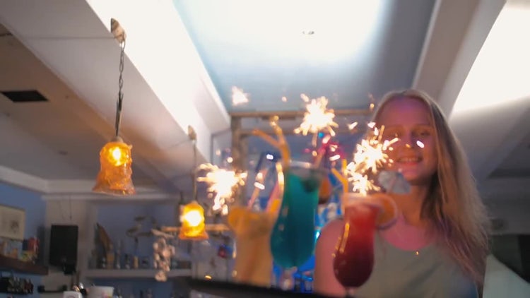 Waitress Carrying Cocktails With Sparklers: Stock Video