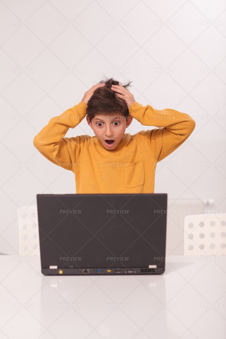 Overwhelmed Boy Looking At Laptop: Stock Photos